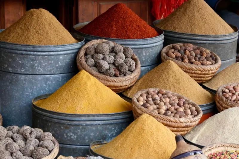 Sacks and baskets of spices and dried goods at a market stall